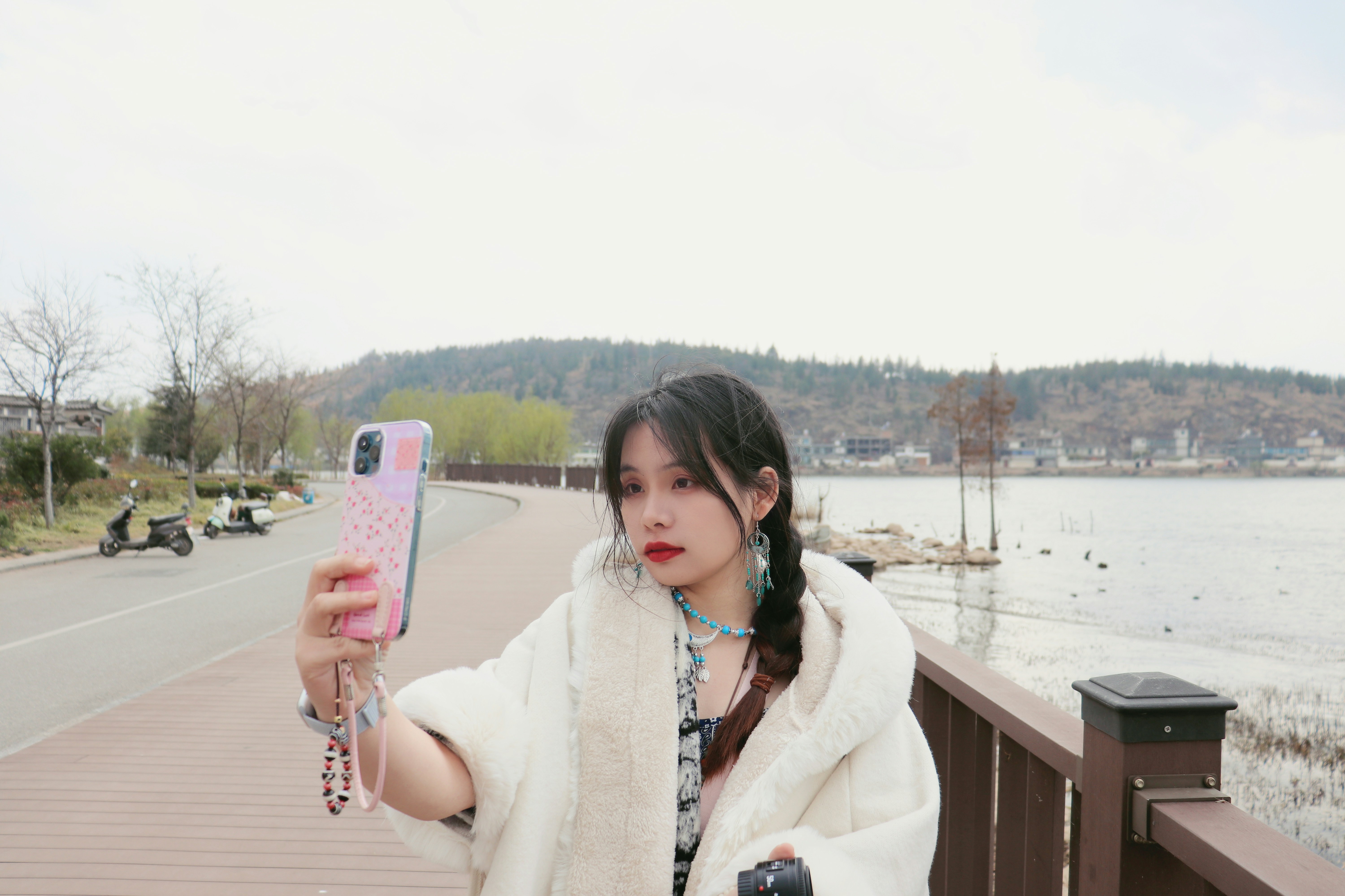 Woman takes a selfie by the water